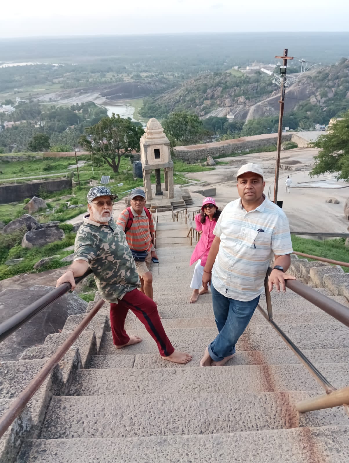 बिटटू बेकार with fellow guides on the hill-top steps of a temple in Karnataka