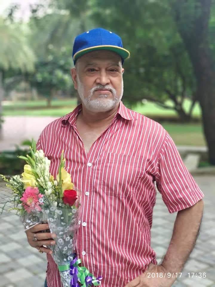 Portrait of बिटटू बेकार holding a bouquet of flowers in a park